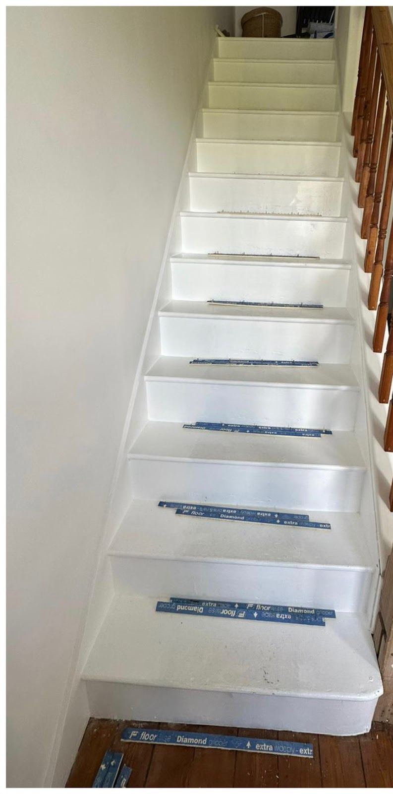Before: bare painted stairs with gripper strips