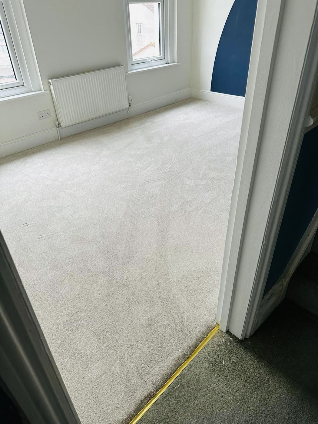 Pale carpet fitted in a bedroom