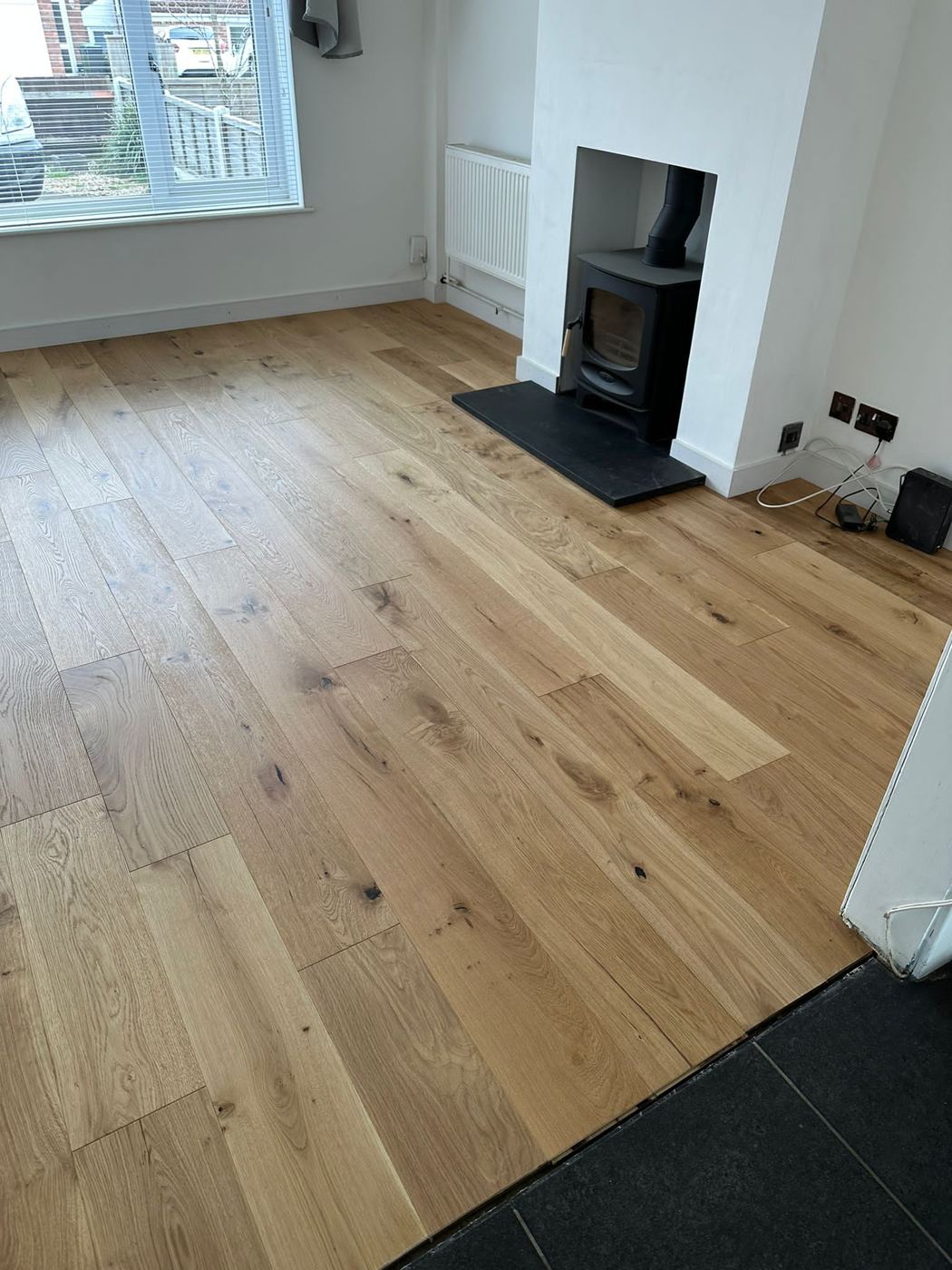 Oak floor in a living room with a log burner