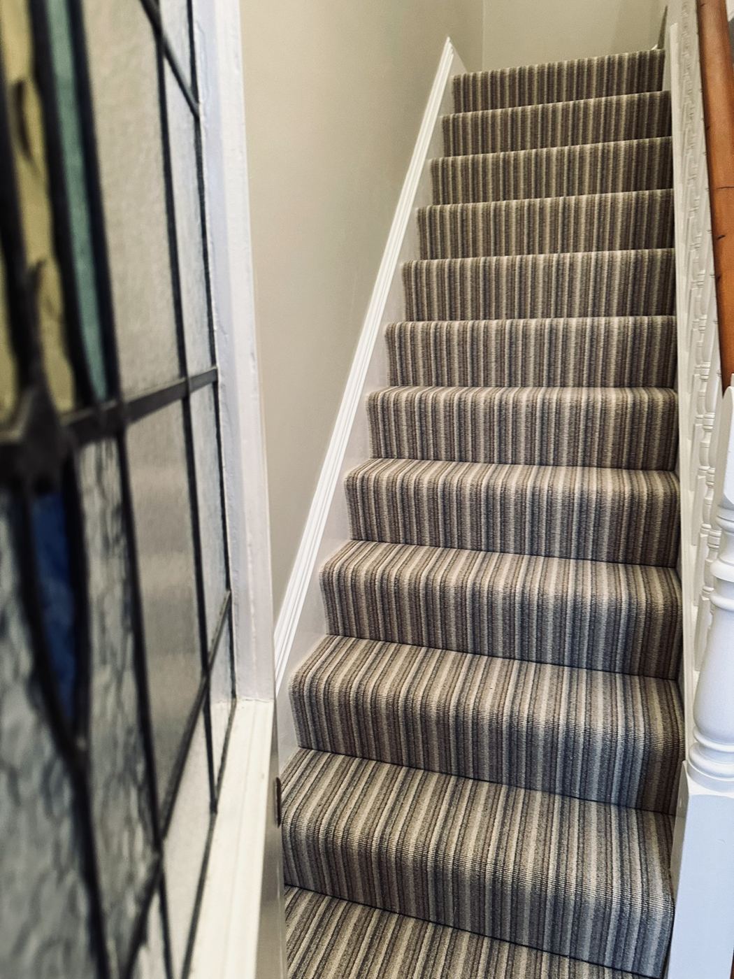 Striped stair carpet in muted tones